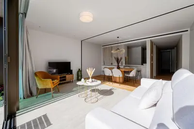 a living room with a white couch and a table at Savoy Residence Monumentalis 2B or Not 2B by LM&AC Signature in Funchal