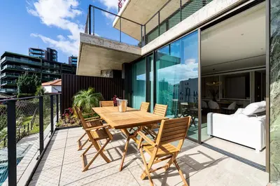 a wooden table on the balcony of a house at Savoy Residence Monumentalis 2B or Not 2B by LM&AC Signature in Funchal