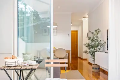 a living room with a table and a chair at Pilar Hills Apartment Funchal, By OP in Funchal