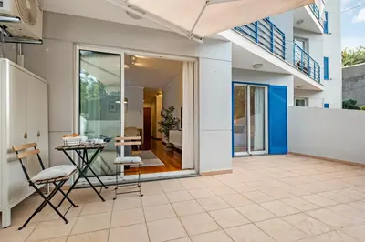 a patio with a table and chairs in a house at Pilar Hills Apartment Funchal, By OP in Funchal