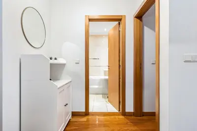 a bathroom with white walls and a mirror and a sink at Pilar Hills Apartment Funchal, By OP in Funchal
