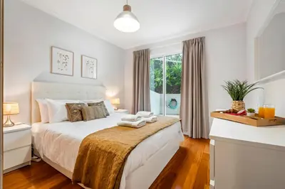 a bedroom with a large white bed with a window at Pilar Hills Apartment Funchal, By OP in Funchal