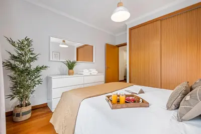 a bedroom with a bed with a tray of fruit on it at Pilar Hills Apartment Funchal, By OP in Funchal