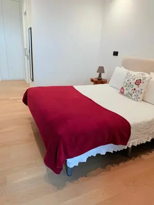 a bedroom with a bed with a red blanket on it at Virtudes Charm in Funchal