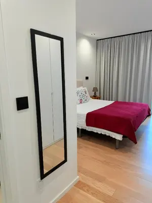 a bedroom with a bed and a mirror at Virtudes Charm in Funchal