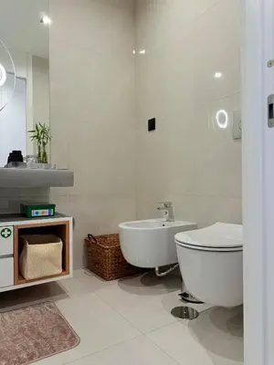 a white bathroom with a toilet and a sink at Virtudes Charm in Funchal