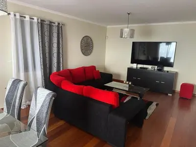 a white house with a blue door on a street at Sea View Andrade 3 Bedroom House in Gaula