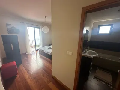 a room with a bathroom with a bed and a sink at Sea View Andrade 3 Bedroom House in Gaula