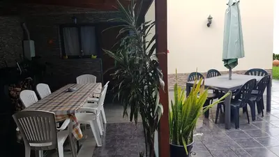 a living room with a glass table and chairs at Sea View Andrade 3 Bedroom House in Gaula