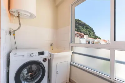 a table with a bottle of wine and glasses at HappyStay by Atlantic Holiday in Ribeira Brava