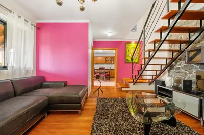 a living room with a couch and a glass table at Casa Rocha in Fajã da Ovelha