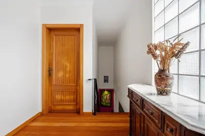 a kitchen with a vase on a counter next to a door at Casa Rocha in Fajã da Ovelha