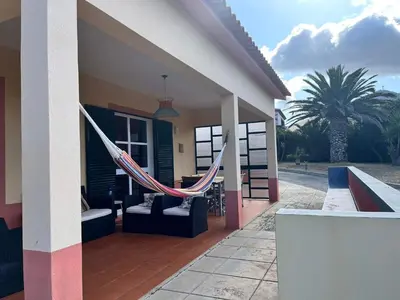 a hammock hanging from the side of a house at Villa Antonius in Porto Santo
