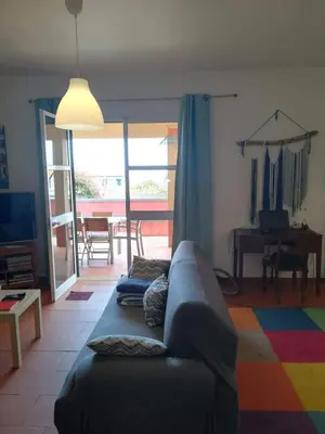 a living room with a couch and a colorful rug at Villa Antonius in Porto Santo