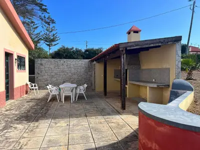 a house with a wooden table and chairs on a patio at Villa Antonius in Porto Santo