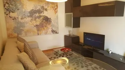 a living room with a couch and a glass table at Funchal - Breathtaking ocean & city view house in Funchal