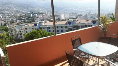 a table and chairs on the balcony of a building at Funchal - Breathtaking ocean & city view house in Funchal