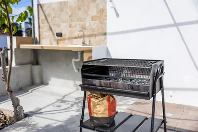 a grill sitting on top of a patio at Porto Santo Beach Side Oasis in Vila Baleira