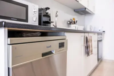 a kitchen with a microwave above a dishwasher at Porto Santo Beach Side Oasis in Vila Baleira