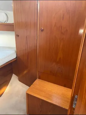 a wooden cabinet in a small room with a bed at eMeM in Calheta