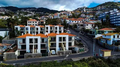 a white bathroom with a sink and a toilet at Villa Frente Mar by ESCAPE to Madeira in Funchal