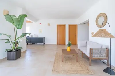 a living room with a couch and a table at The Suites by The Lighthouse Arrifana in Aljezur
