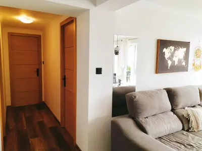 a living room with a couch next to a door at Jungle Lodge in Machico