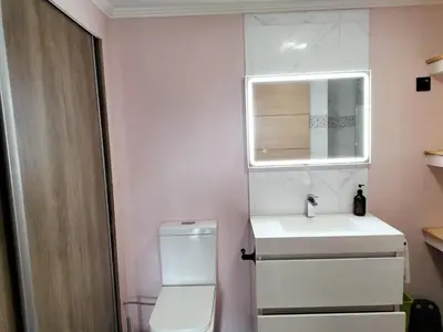 a bathroom with a toilet and a sink and a mirror at Jungle Lodge in Machico