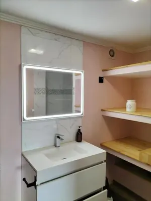 a bathroom with a sink and a mirror at Jungle Lodge in Machico