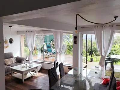a living room with a couch and a table at Jungle Lodge in Machico