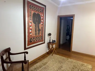 a living room with a chair and a picture on the wall at 2 Madeira Inn Group in Funchal