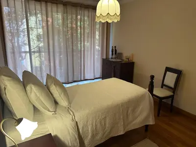 a bedroom with a bed and a chair and a window at 2 Madeira Inn Group in Funchal