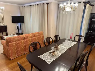 a dining room with a table and a couch at 2 Madeira Inn Group in Funchal
