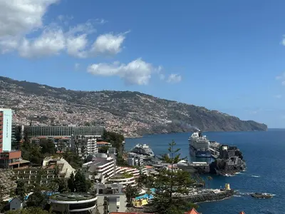 a view of a city and the ocean with buildings at 2 Madeira Inn Group in Funchal