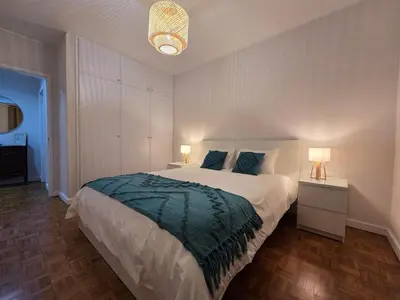 a bedroom with a large bed and two lamps at The Infante Stay in Funchal