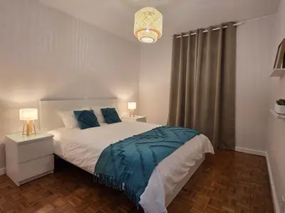 a bedroom with a large bed with blue sheets at The Infante Stay in Funchal