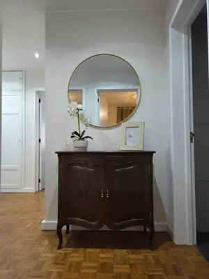 a mirror on top of a dresser in a hallway at The Infante Stay in Funchal