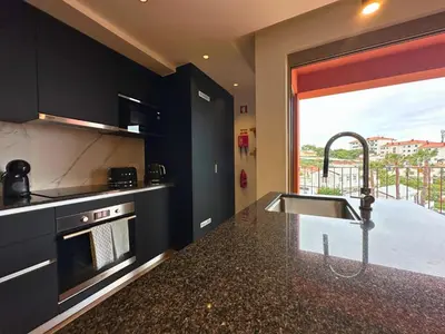 a kitchen with a sink and a counter top at Colours by Madeira Best Apartments in Funchal