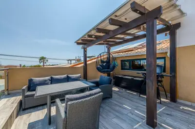 a patio with a wooden deck with a pergola at Bela Vista Exclusive Private Villa in Praia da Luz in Luz