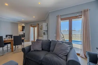 a living room with a couch and a table at Bela Vista Exclusive Private Villa in Praia da Luz in Luz