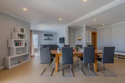 a dining room with a wooden table and chairs at Bela Vista Exclusive Private Villa in Praia da Luz in Luz