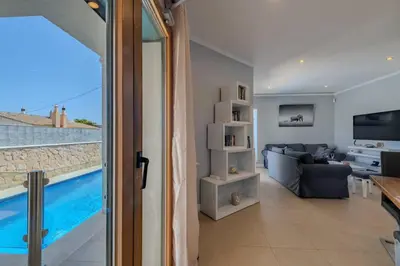 a living room with a view of a pool at Bela Vista Exclusive Private Villa in Praia da Luz in Luz