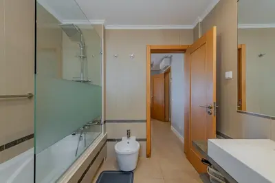 a bathroom with a toilet and a shower and a sink at Bela Vista Exclusive Private Villa in Praia da Luz in Luz