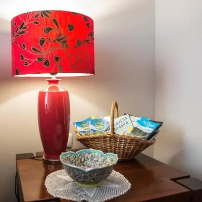 a red lamp sitting on a table with a basket of chips at Casa da Avó - Vila do Porto in Vila do Porto