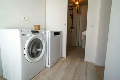 a white washer and dryer in a room at Modern Old Town House with Sunny Terrace in Vila do Bispo