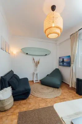 a living room with a couch and a chandelier at Modern Old Town House with Sunny Terrace in Vila do Bispo