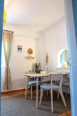 a dining room with a table and chairs at Modern Old Town House with Sunny Terrace in Vila do Bispo