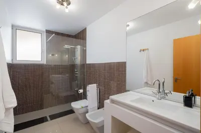 a bathroom with a sink and a toilet and a shower at Private pool and sea view - Tropical Villa in Arco da Calheta