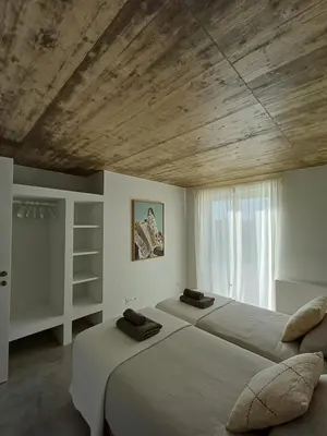 a bedroom with two beds and a wooden ceiling at Casa Fá - NEW T4 - Aljezur in Aljezur