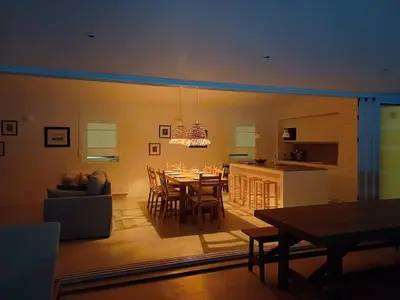 a dining room and kitchen with a table and chairs at Casa Fá - NEW T4 - Aljezur in Aljezur